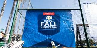 Tennis equipment rests along an event banner at the 2019 Oracle ITA National Fall Championships