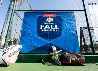 Tennis equipment rests along an event banner at the 2019 Oracle ITA National Fall Championships